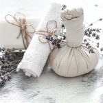 Spa and wellness setting with flowers and towels. Bright composition with lavender flowers. Dayspa nature products with coconut